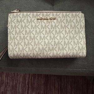 Michael kors cellphone/wallet with strap.